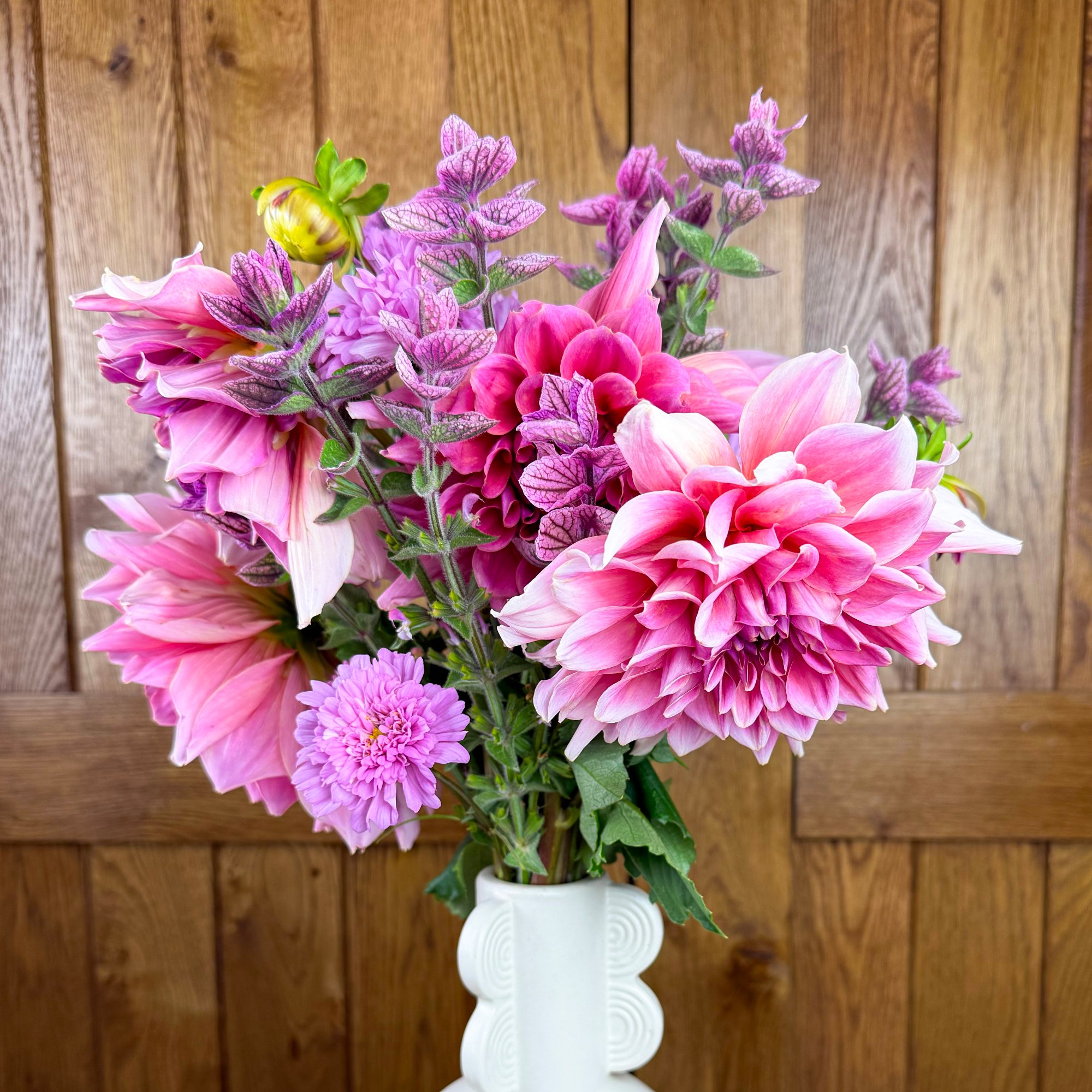 A pink market bouquet containing dahlia, cosmos, and salvia.